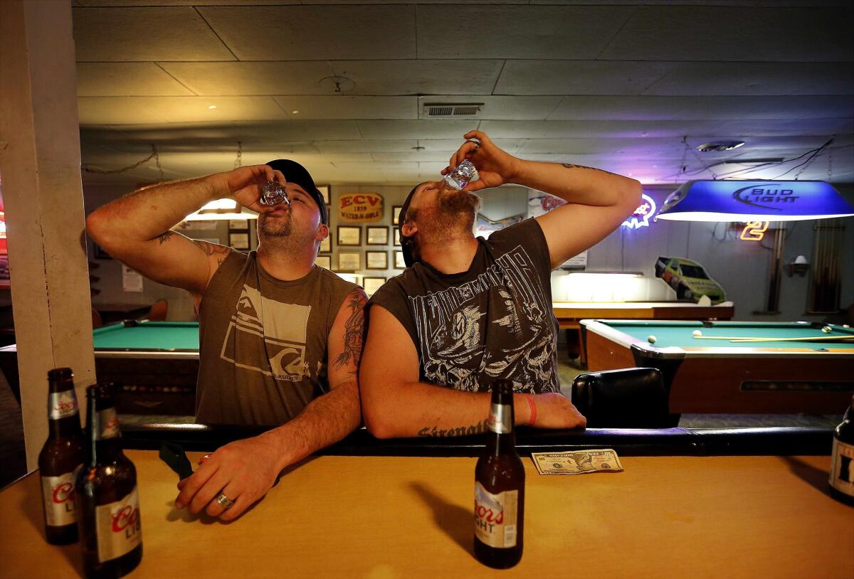 Keven Jones, left, takes a shot of whiskey with brother Dave Frokemke at Sportsman Tavern.