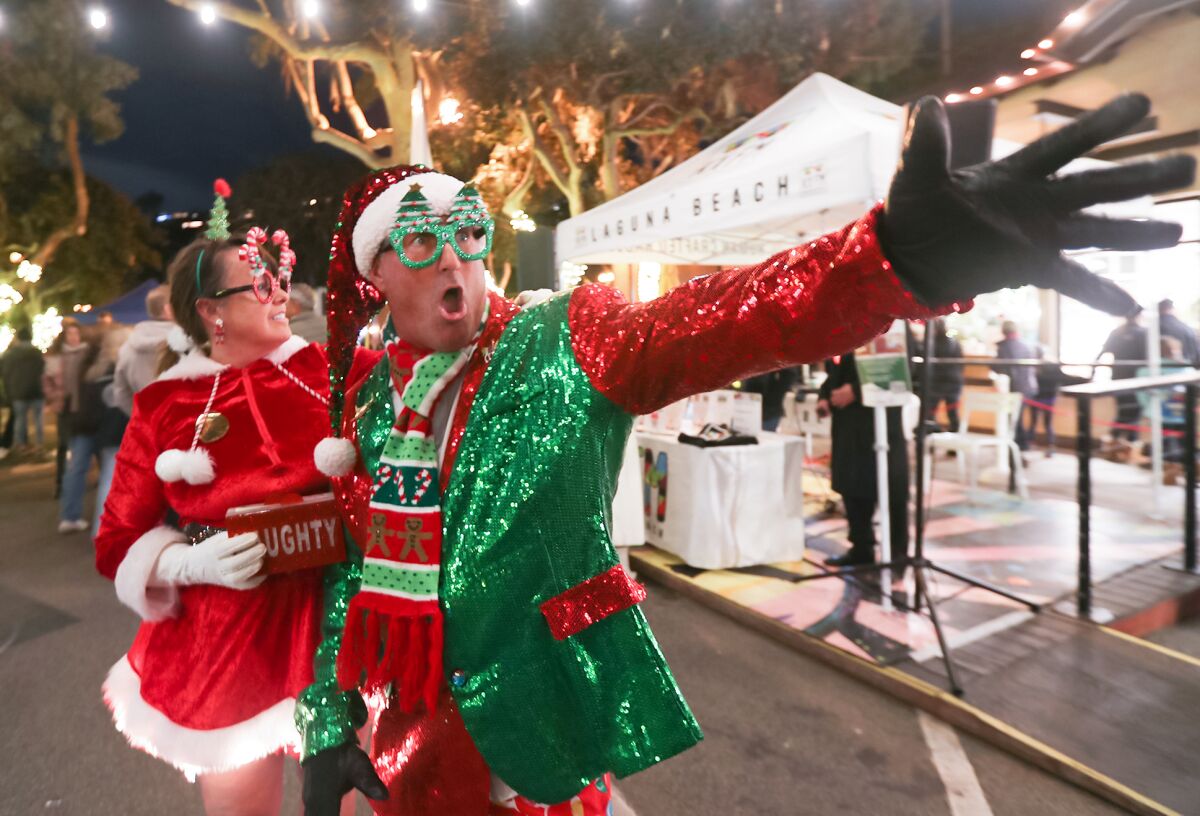 Surf instructor Goff Stepien wears a super elf costume as he entertains guests during Hospitality Night in Laguna Beach.