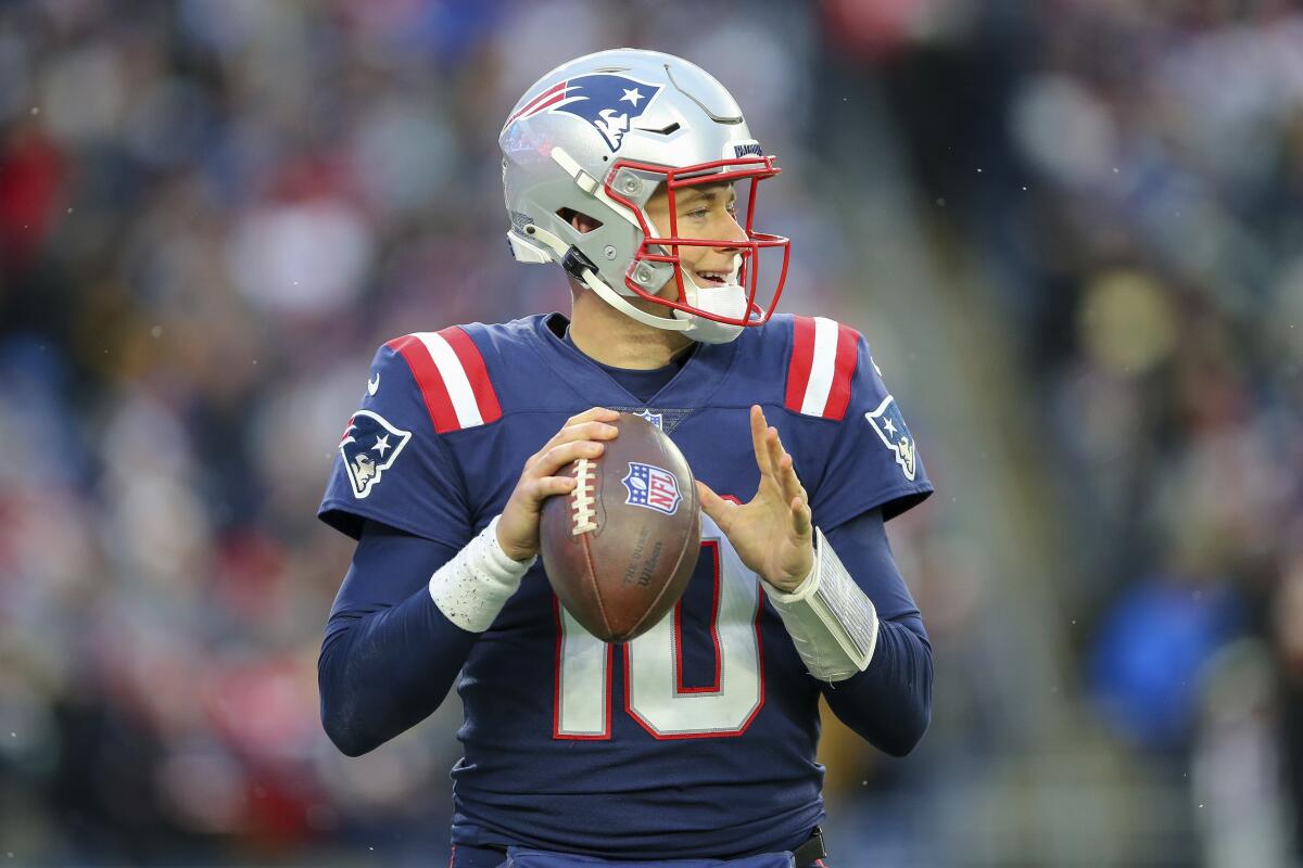 New England Patriots quarterback Mac Jones warms up.