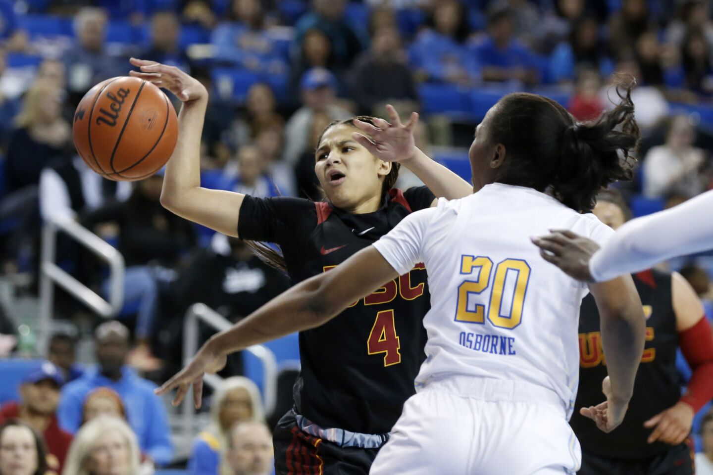UCLA guard Charisma Osborne, right, knocks the ball away from USC guard Endyia Rogers during the first half.