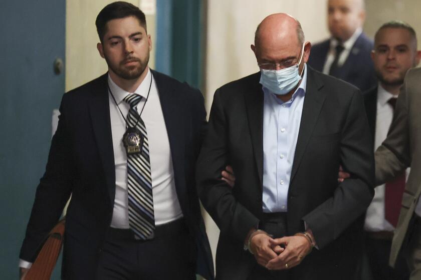 Allen Weisselberg, right, is escorted to Manhattan criminal court, Monday, March 4, 2024, in New York. Weisselberg, the former chief financial officer of the Trump Organization, surrendered to the Manhattan district attorney Monday morning for arraignment on new criminal charges, the prosecutor's office said. (AP Photo/Yuki Iwamura)