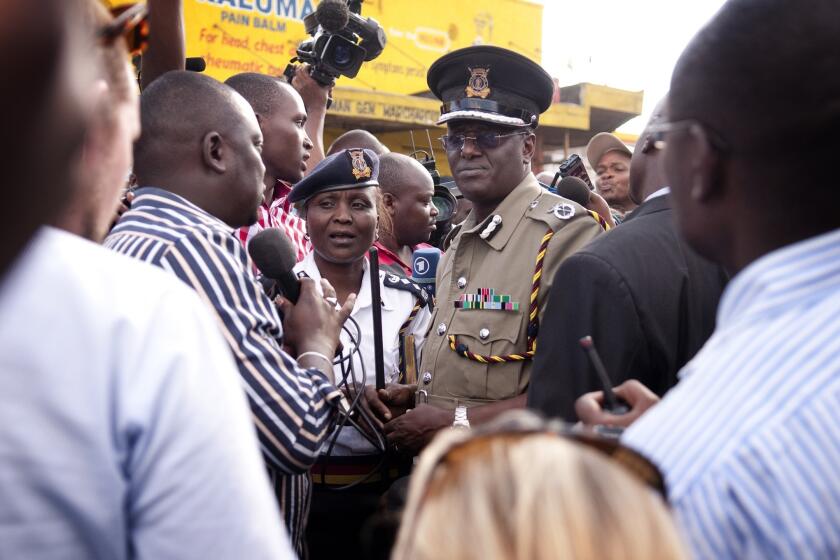 Kenyan Police Chief David Kimaiyo, pictured speaking to journalists last month after several bombings in Nairobi, said a group of gunmen arrived in Mpeketoni by van before the attacks Sunday night.