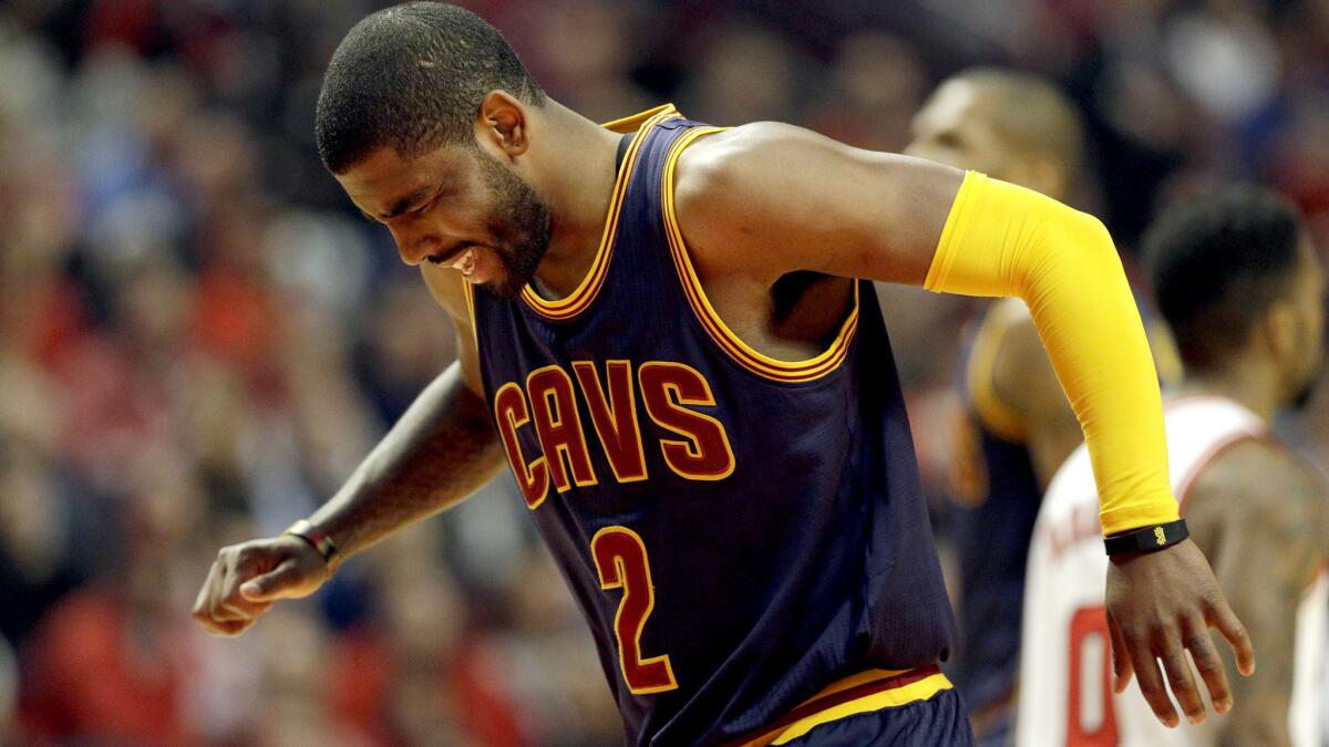 Cavaliers All-Star point guard Kyrie Irving grimaces after aggravating an injury in the first half of Game 6 against the Bulls on Thursday.