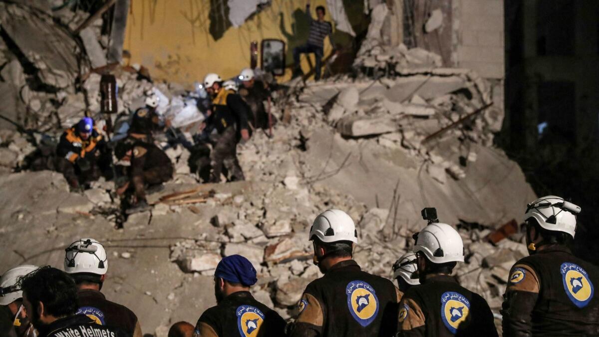 White Helmets volunteers search for survivors after an explosion in Idlib, Syria, on April 9. Hundreds of the Syrian rescue workers stranded along the frontier with the Israeli-occupied Golan Heights have been evacuated.