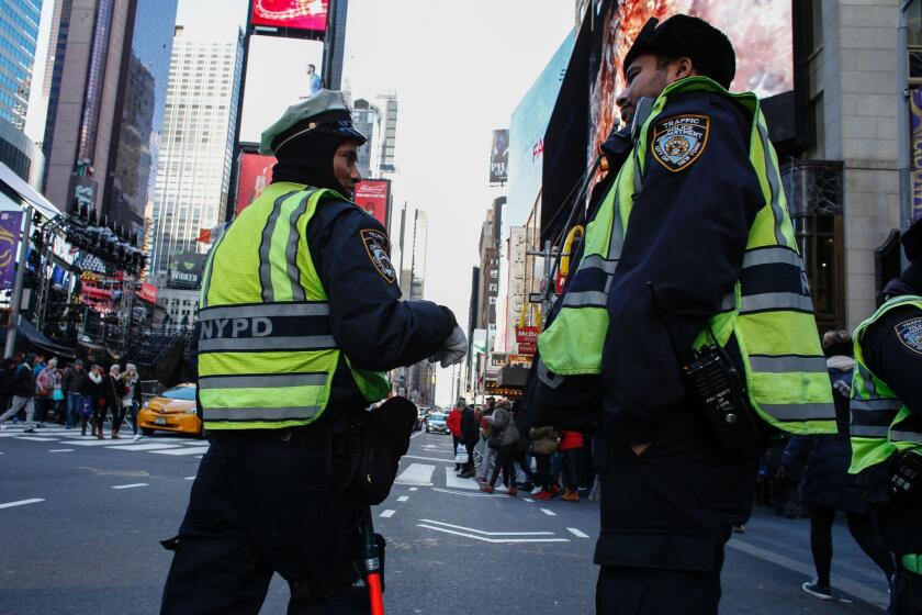 Police officers patrol Times Square on Dec. 30 as New York City prepares to welcome nearly 2 million people for New Year's Eve celebrations.