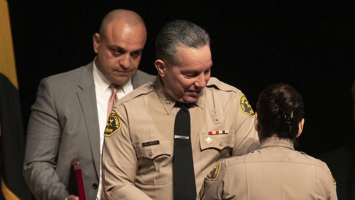 Los Angeles County Sheriff's Deputy Caren Carl Mandoyan, left, and Sheriff Alex Villanueva in 2018.