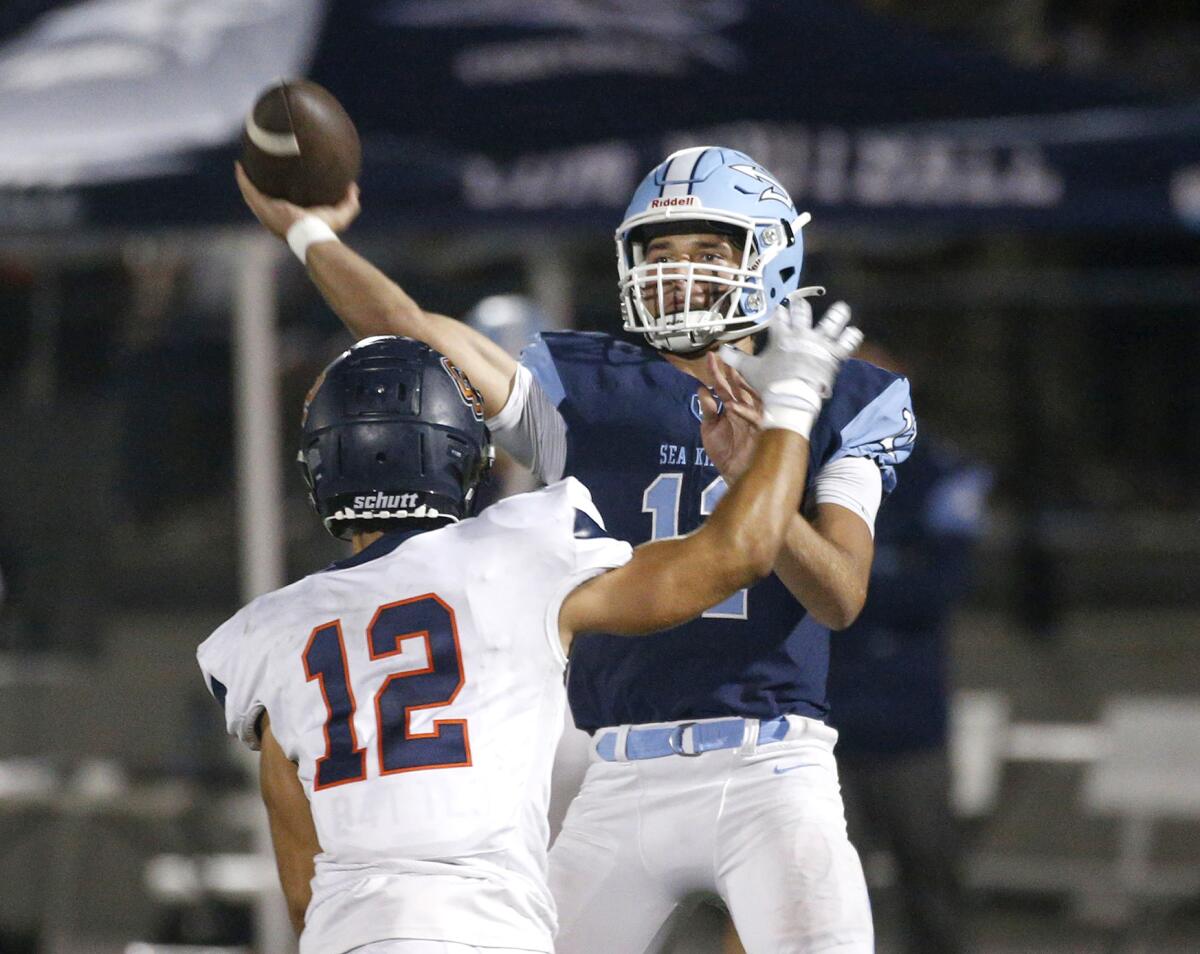 Corona del Mar quarterback Kaleb Annett gets a pass away under pressure during Friday's game.