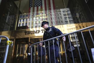 A police officer places a barricade in front of Trump Tower, on Tuesday, March 21, 2023, in New York. (AP Photo/Bryan Woolston)