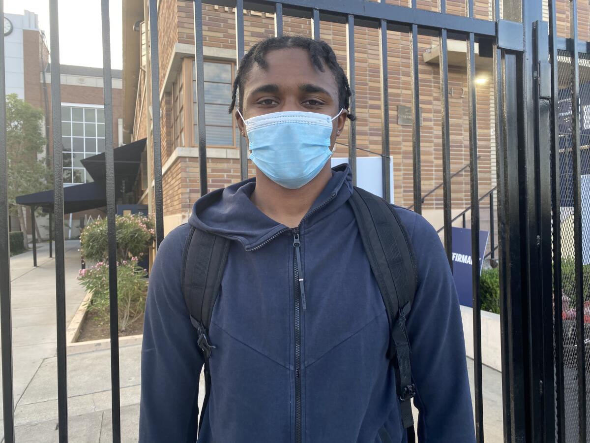 Defensive back Zakhari Spears of Loyola, shown standing in front of a gate wearing a mask, will sign with Washington 
