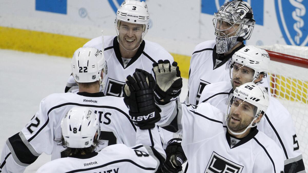 Kings players celebrate a 4-0 victory over the Minnesota Wild in St. Paul on Nov. 26.