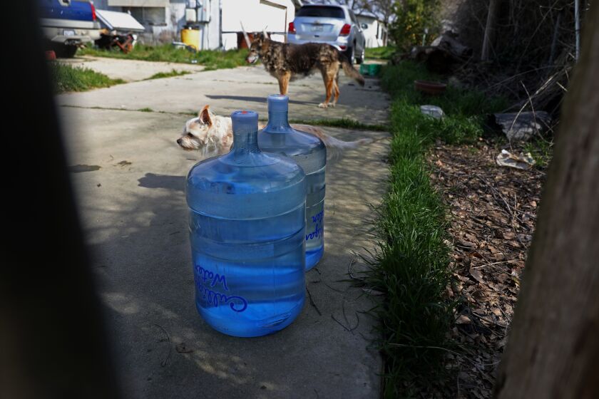 SANGER, CA - FEBRUARY 21: Ray Cano, 51, homeowner since 1988, has drinking water delivered to his home every two weeks, along Cottle Ave. in the Tombstone neighborhood, unincorporated Fresno County, on Tuesday, Feb. 21, 2023 in Sanger, CA. Cano has a 140-ft deep water well on his property. He would like to be hooked up to the City of Sanger water supply. In the community of Tombstone in Fresno County, residents' wells have continued going dry during the drought as nearby farms have heavily pumped groundwater, drawing down the water levels. Residents have lost access to water and are now depending on tanks and deliveries of water by truck. A potential solution for the area would involve connecting to water pipes from nearby Sanger, but progress has been slow. (Gary Coronado / Los Angeles Times)