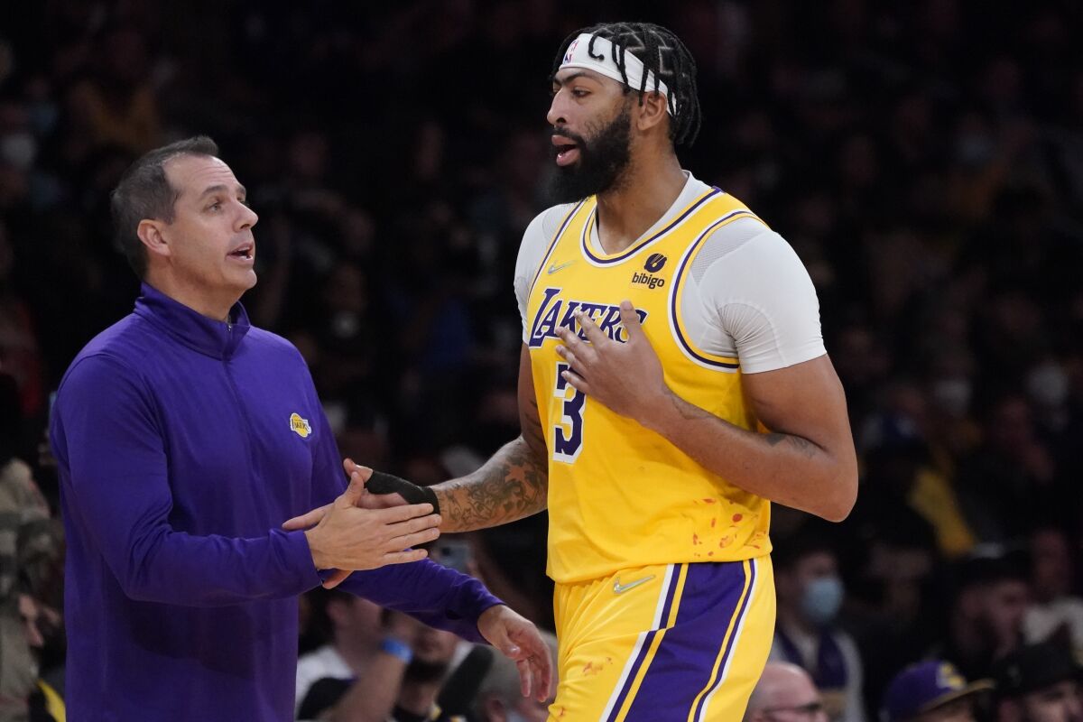 Los Angeles Lakers forward Anthony Davis shakes hands with head coach Frank Vogel.