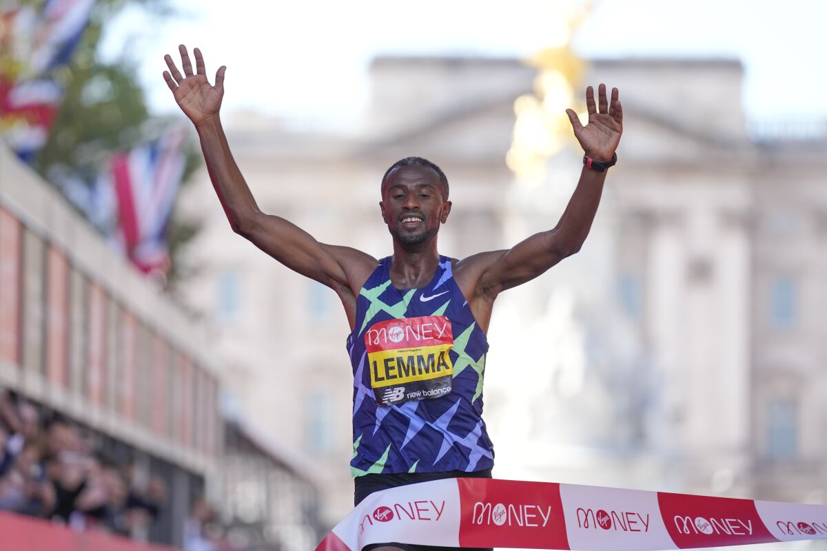 Ethiopia's Sisay Lemma crosses the finish line to win the Men's race in the London Marathon in central London, Sunday, Oct. 3, 2021. (AP Photo/Kirsty Wigglesworth)