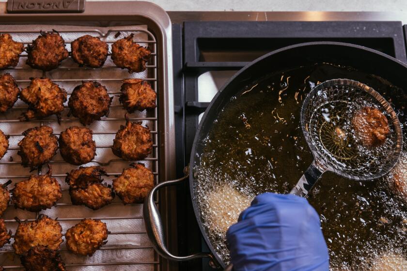 Los Angeles, CA - November 29: Middle Eastern Style Latkes are deep fried in oil at the Los Angeles Times' studio kitchen on Tuesday, Nov. 29, 2022 in Los Angeles, CA.(Dania Maxwell / Los Angeles Times)