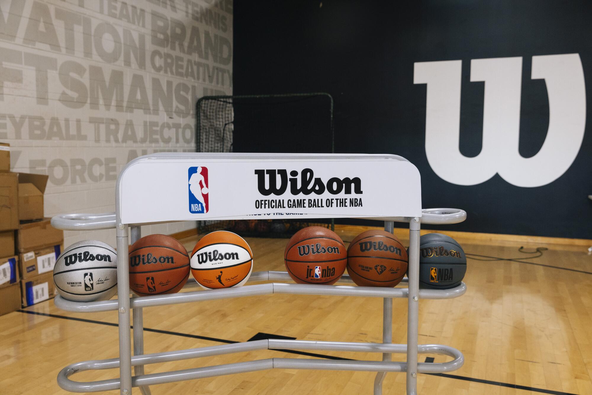 A selection of basketballs is displayed on the test court at the Wilson Innovation Center.