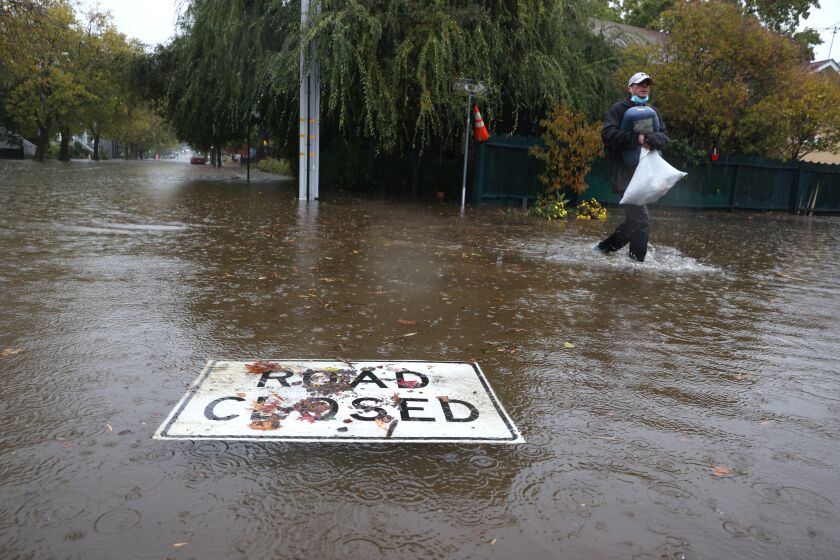 SAN RAFAEL, CALIFORNIA - OCTOBER 24: A road closed sign floats on a flooded street on October 24, 2021 in San Rafael, California. A Category 5 atmospheric river is bringing heavy precipitation, high winds and power outages to the San Francisco Bay Area. The storm is expected to bring anywhere between 2 to 5 inches of rain to many parts of the area. (Photo by Justin Sullivan/Getty Images)