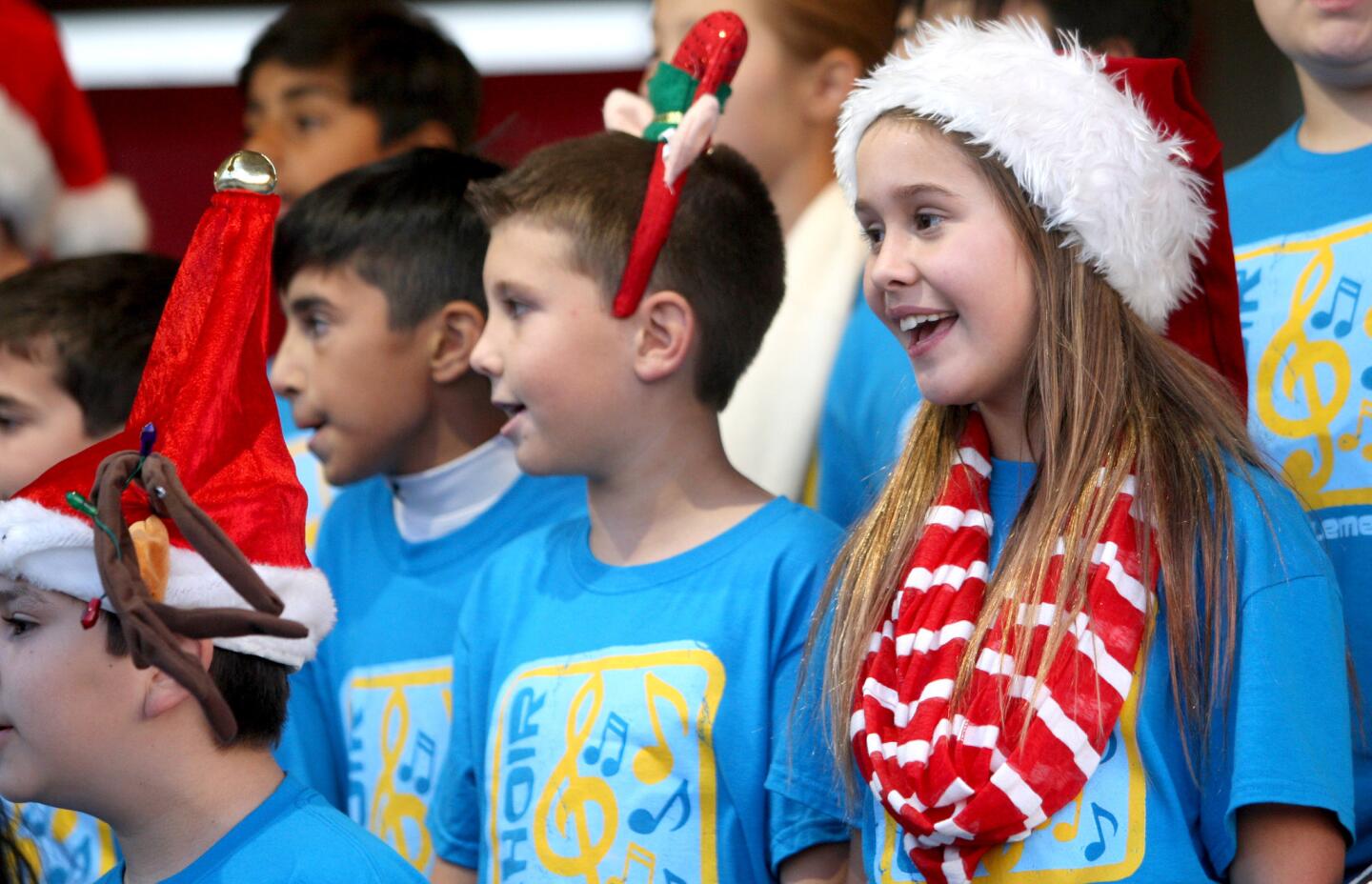 Arwyn Dilbeck and other members of the La Cañada Elementary School Lion's Pride Chorus sang holiday songs for the crowds gathered at the 21st Festival in Lights at Memorial Park in La Cañada Flintridge on Friday, Dec. 4, 2015.