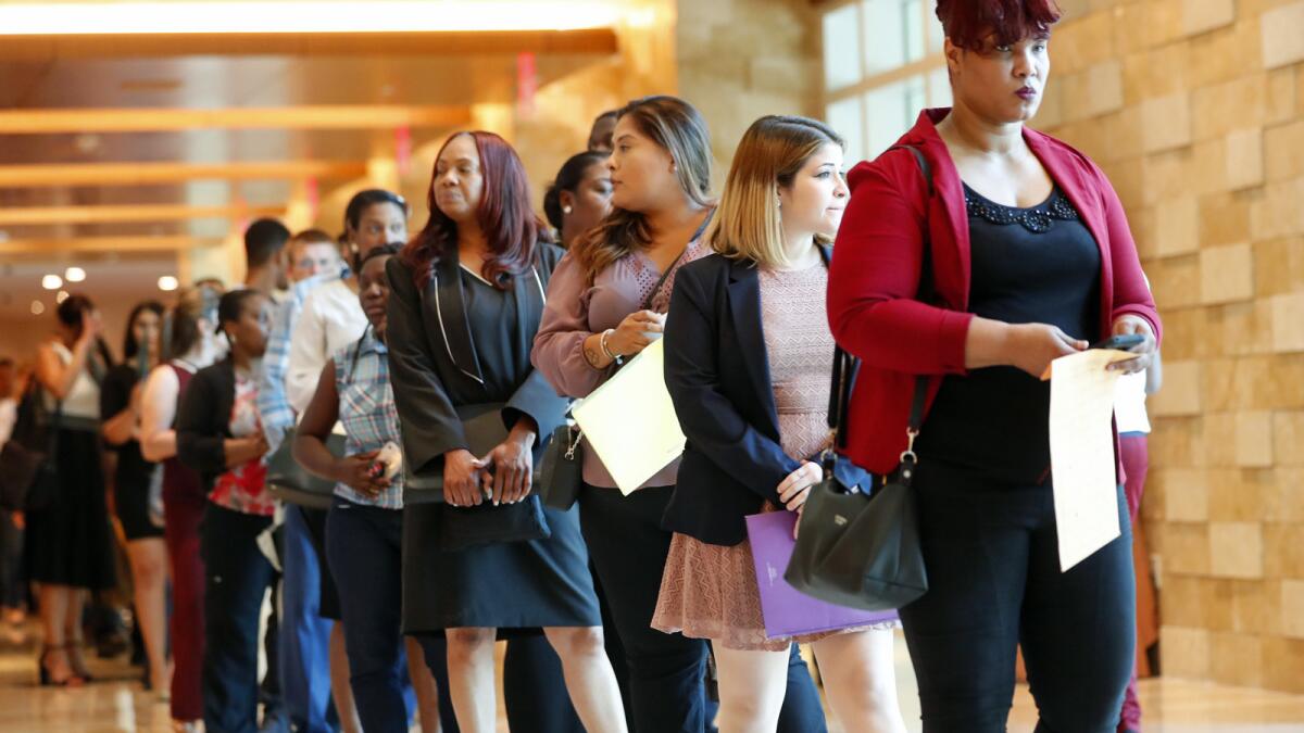 Applicants line up at the Seminole Hard Rock Hotel & Casino during a job fair last month in Hollywood, Fla.