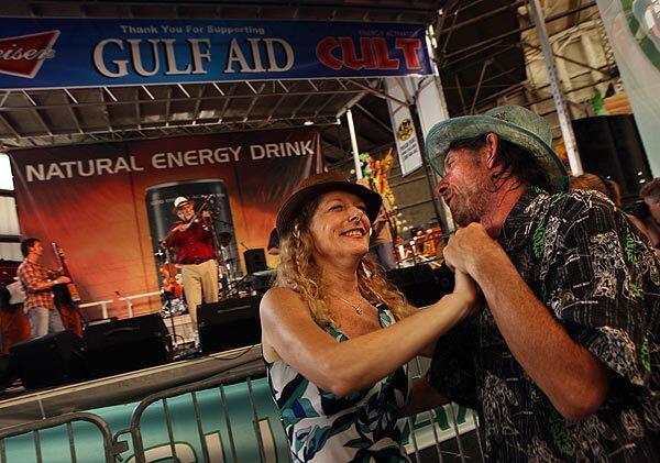 Elizabeth Fredrickson and Bill Wheeler dance to music by violinist Michael Doucet and others at Gulf Aid, a benefit concert for those affected by the oil spill in the Gulf of Mexico. Full coverage of the oil spill