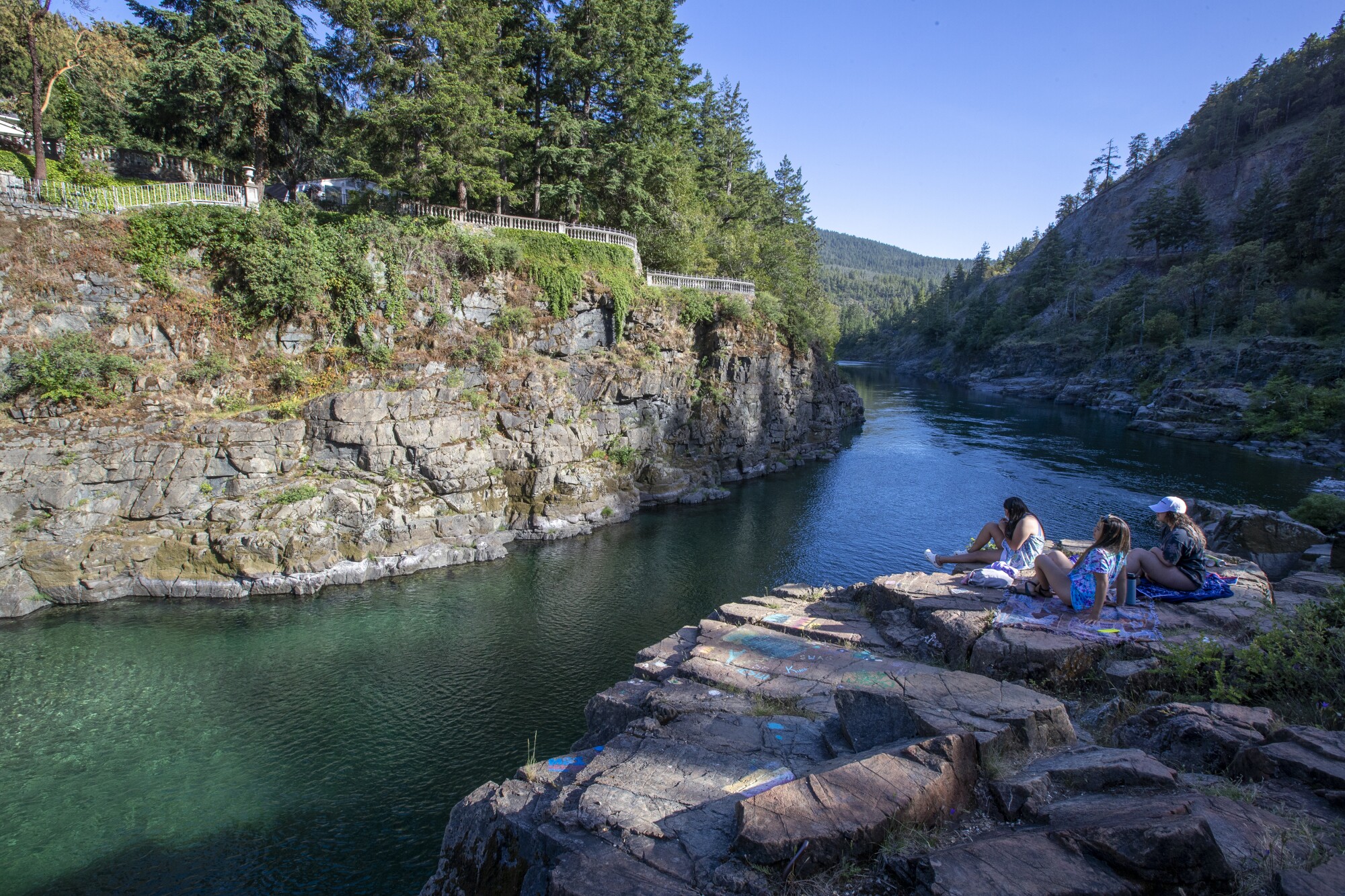 People relax on a bluff overlooking the Smith River