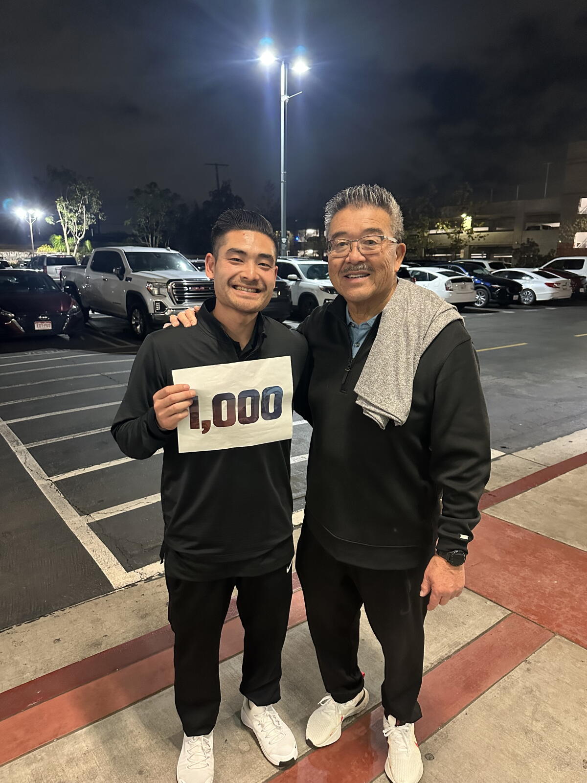 Corey Kitani (left), the nephew of coach Harvey Kitani, needs only 991 coaching wins to reach his uncle's achievement.