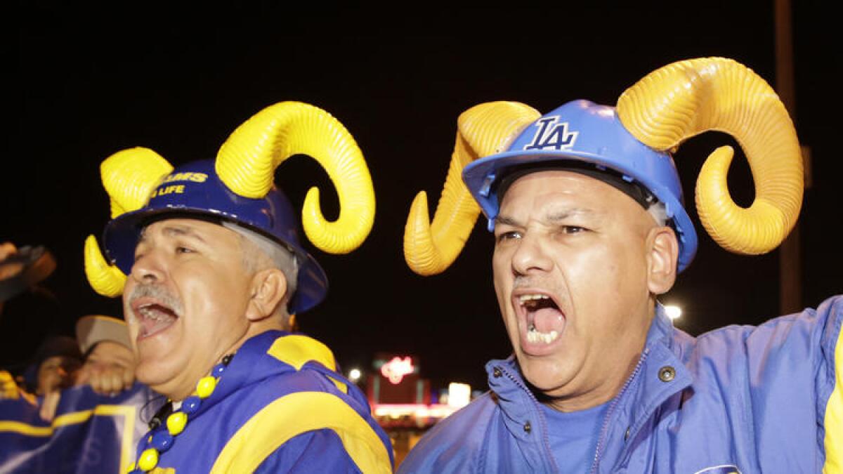 Football fans cheer for the return of the Rams to Los Angeles on the site of the old Hollywood Park horse-racing track in Inglewood on Tuesday, Jan. 12, 2016. Should switching venues be an opportunity to switch up the uniforms? Some fans say: "Don't mess with the horns."