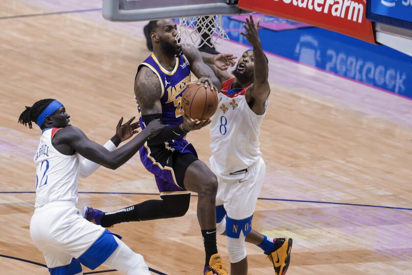 Los Angeles Lakers forward LeBron James (23) drives to the basket against New Orleans Pelicans forward Wenyen Gabriel.