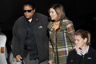 House Speaker Nancy Pelosi, center, is escorted to a vehicle outside of her San Francisco home on Wednesday.