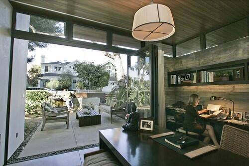 Forget great rooms, walk-in closets and spa-like bathrooms. The home office has become the new staple of the American home. Among the examples of how Southern Californians are incorporating work spaces into their homes: the Manhattan Beach residence of architect Grant Kirkpatrick. Here, wife Shaya works in her home office, where wide doors open to the front patio.