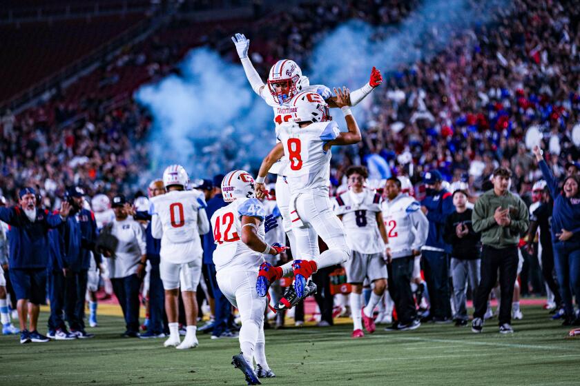 Garfield players celebrate from last year's East. L.A. Classic against Roosevelt. On Friday, they play at SoFi Stadium.