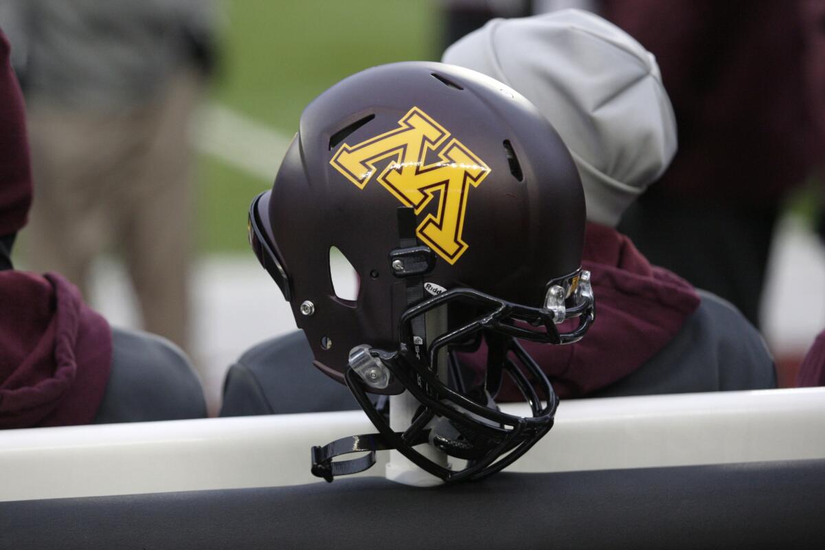 A Minnesota helmet hangs on a sideline heater during a game in Minneapolis against Michigan State on Nov. 24, 2012.