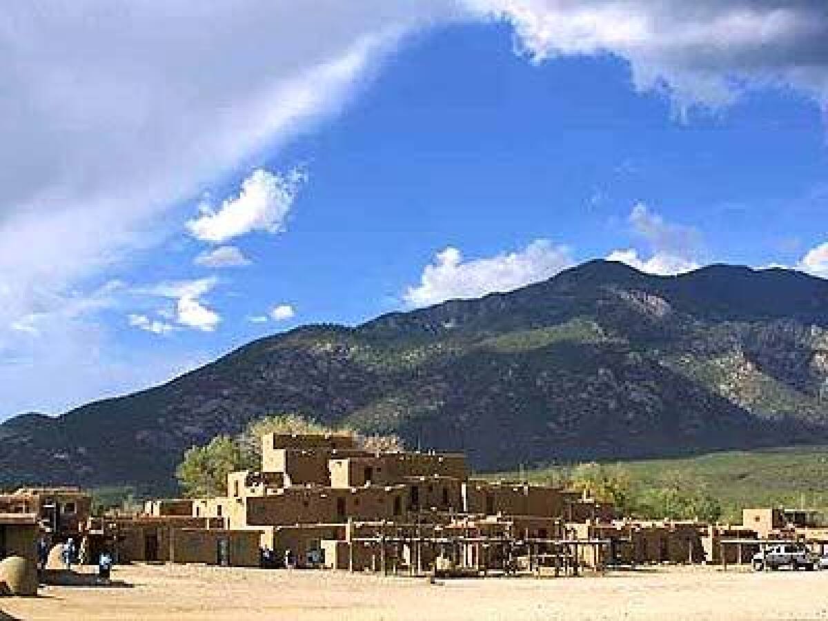 The adobe construction and flat roofs of historic Taos Pueblo in New Mexico have been repeated around the Southwest to become the regions characteristic architectural style.