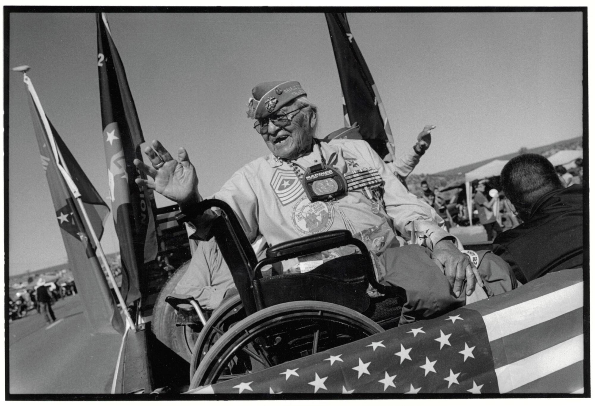 A man waves during a parade.