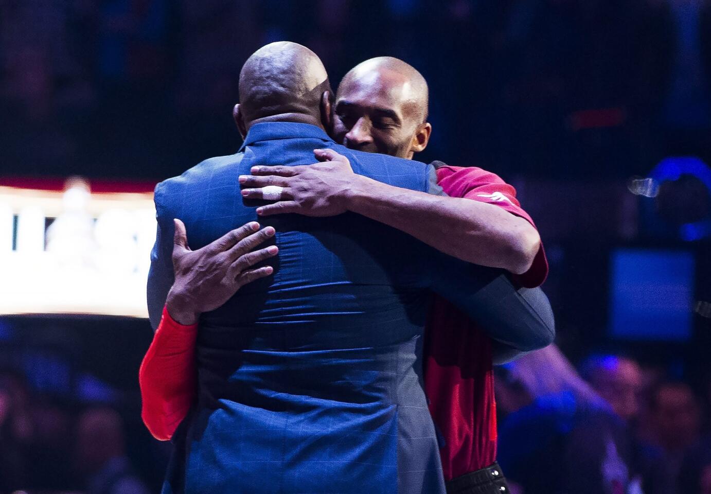 Western Conference's Kobe Bryant, of the Los Angeles Lakers, right, hugs Magic Johnson, left, as he is introduced before the first half of the NBA all-star basketball game, Sunday, Feb. 14, 2016 in Toronto. (Mark Blinch/The Canadian Press via AP) MANDATORY CREDIT