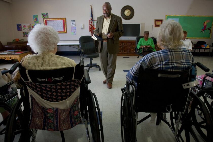 The Rev. Eric Smith helps convalescing seniors at Paradise Valley Manor and Health. Here, Smith leads the group through hymns. Nelvin C. Cepeda / Union-Tribune