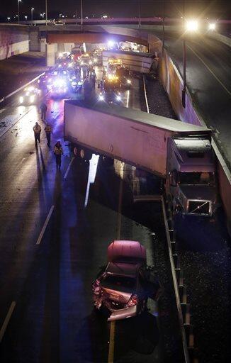 The scene of a multi-vehicle accident that closed the New Jersey Turnpike Monday, Feb. 9, 2015, near Cranbury, N.J. A highway pileup involving 15 or more vehicles including box trucks, tractor-trailers and a bus on Monday night left at least one person dead and several others injured. (AP Photo/Mel Evans)