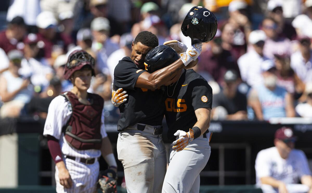Tennessee's Christian Moore, left, hugs Dylan Dreiling after he hit a two-run homer in the seventh inning against Texas A&M.