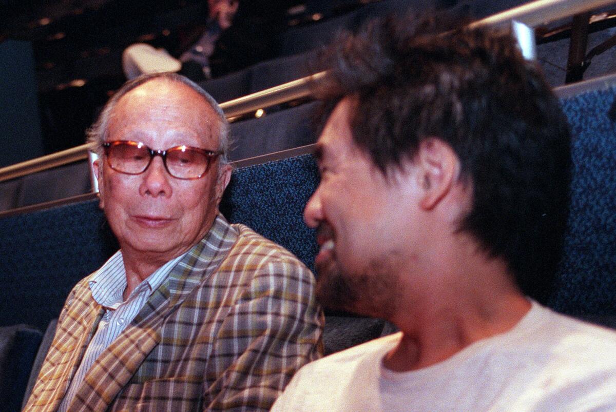 C.Y. Lee, left, with David Henry Hwang at a dress rehearsal for the 2001 production of 'Flower Drum Song' at the Mark Taper Forum. Hwang revived the musical based on Lee's novel for a new generation.