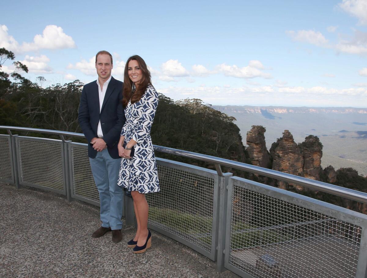 The Duke of Cambridge, Britain's Prince William, left, and his wife, the Duchess of Cambridge, dressed in Diane von Furstenberg, pose in front of the Three Sisters rock formation in the Blue Mountains during a tour of Echo Point in Katoomba.