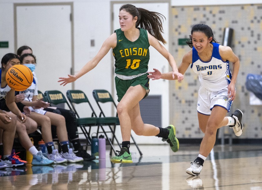 Edison's Gwen Ontiveros and Fountain Valley's Mary Nguyen charge up court at the Christina Mauser Memorial Tournament.