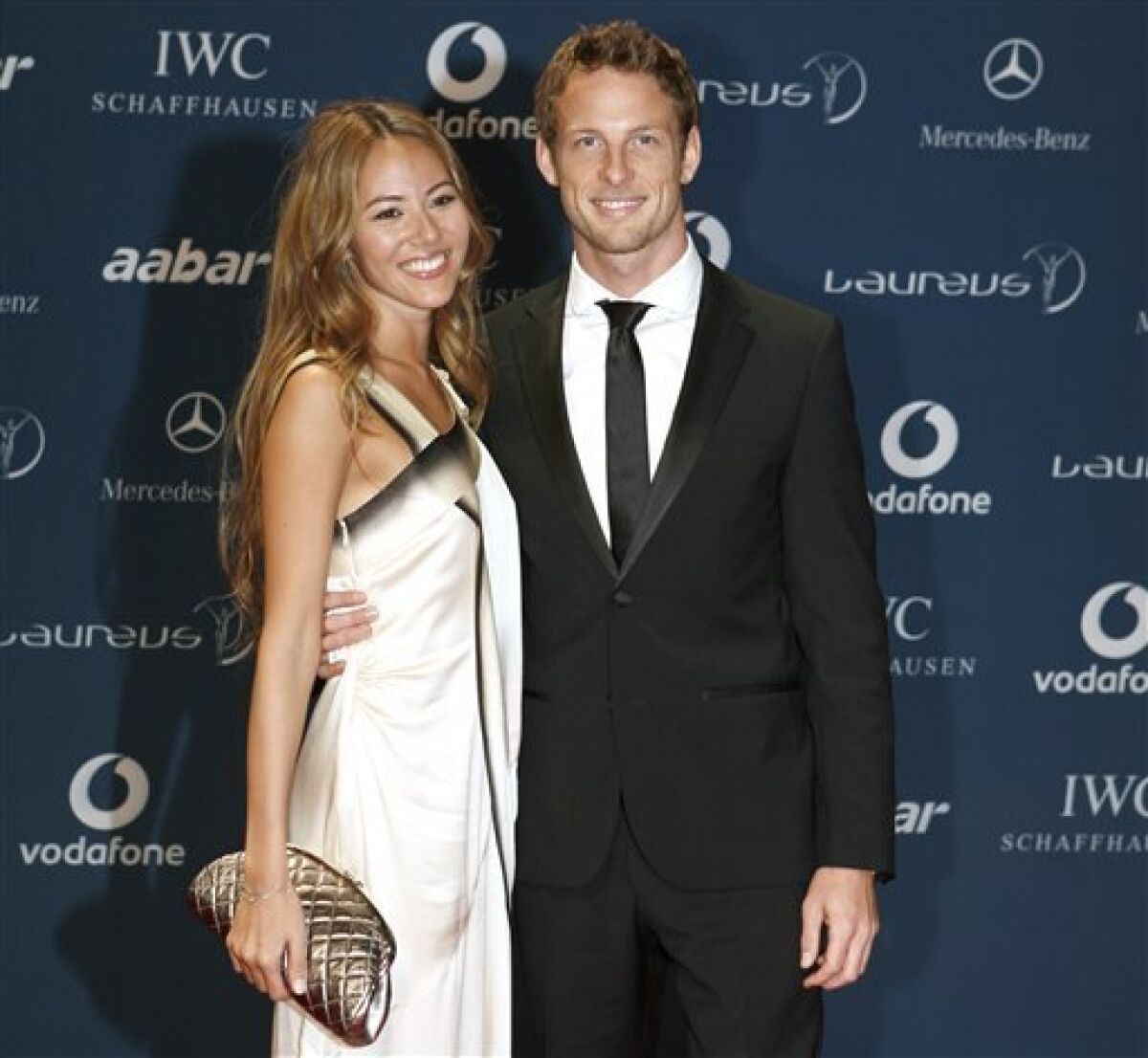 British F1 driver Jenson Button with his companion arrives for the Laureus Awards in Abu Dhabi, United Arab Emirates, Wednesday March 10, 2010. (AP Photo/Farhad Berahman)