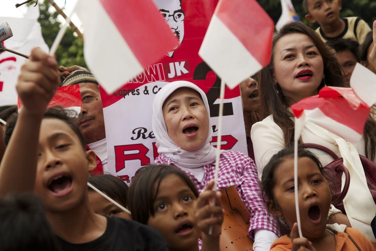Supporters of Joko Widodo, the president-elect of Indonesia, cheer at his election victory rally in Jakarta on July 23.