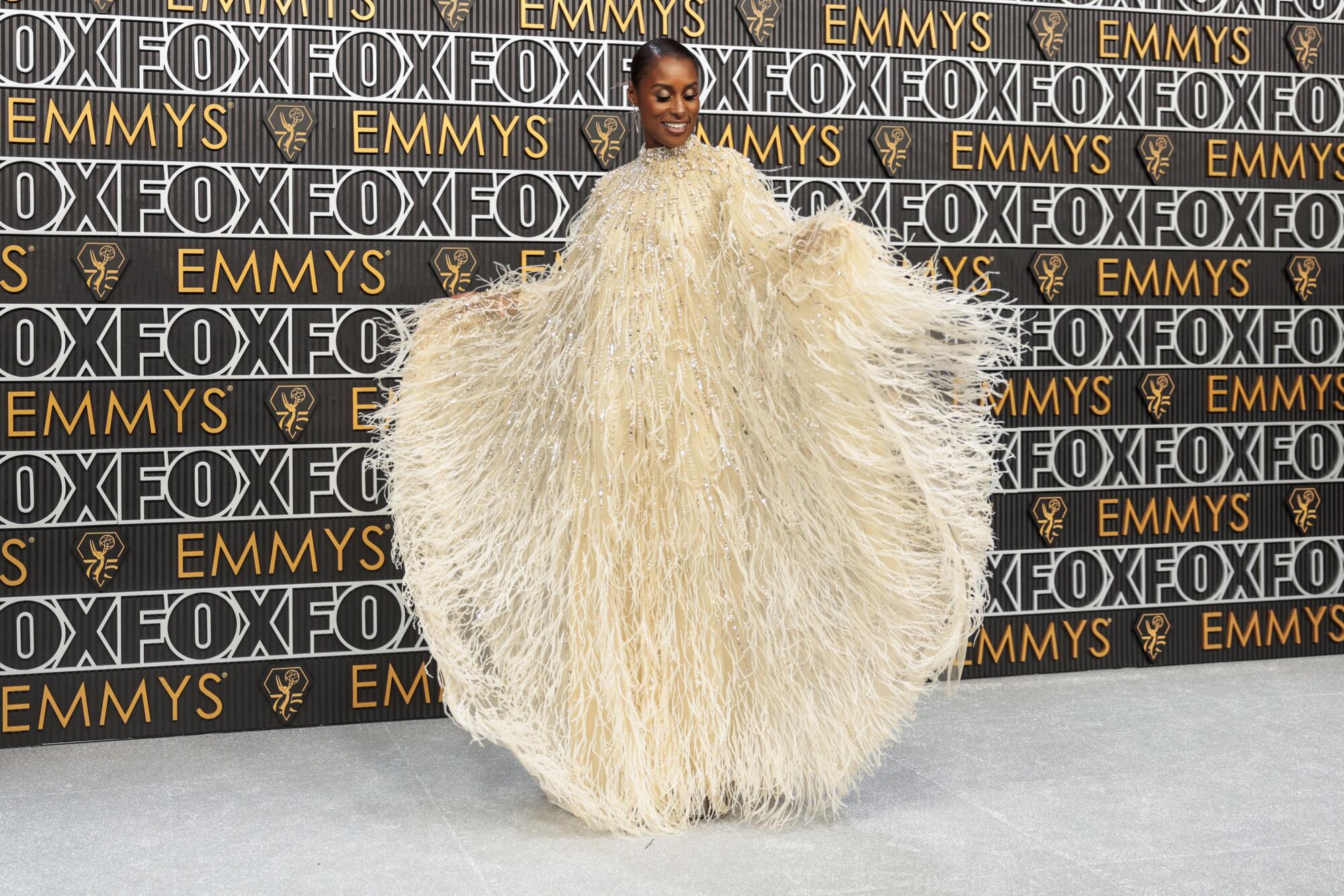 Issa Rae poses on the Emmys red carpet. 