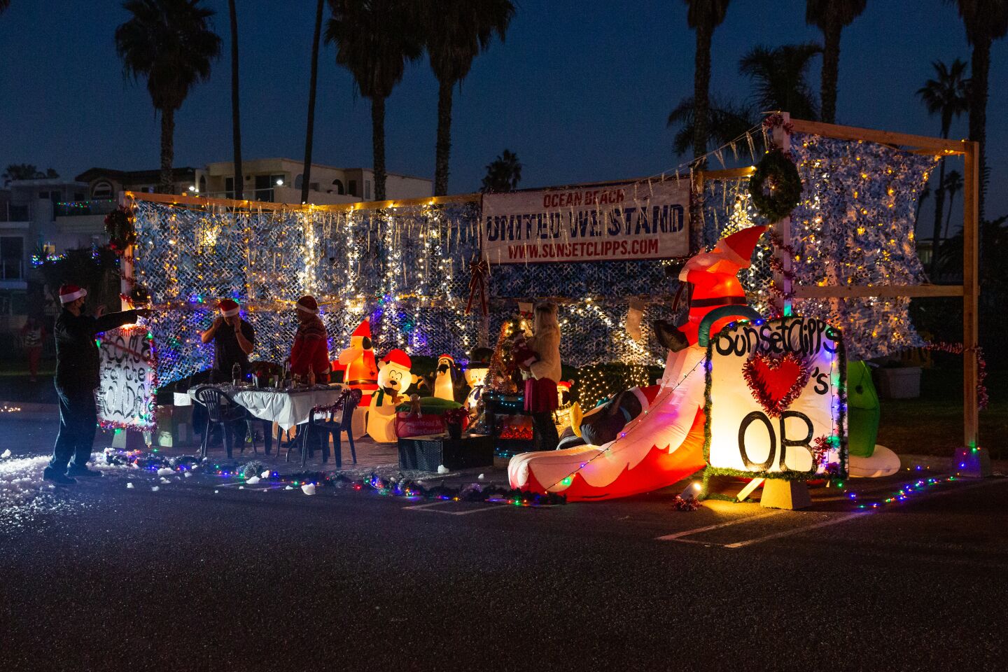 Sunset Clipps barbershop/hair salon turns out for the Ocean Beach Holiday Parade on Dec. 5 in the Dog Beach parking lot.