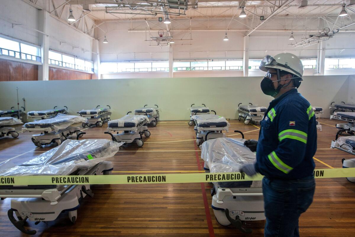 Workers convert the gym of the steel company Ternium into a field hospital for COVID-19 patients in Monterrey, Mexico.