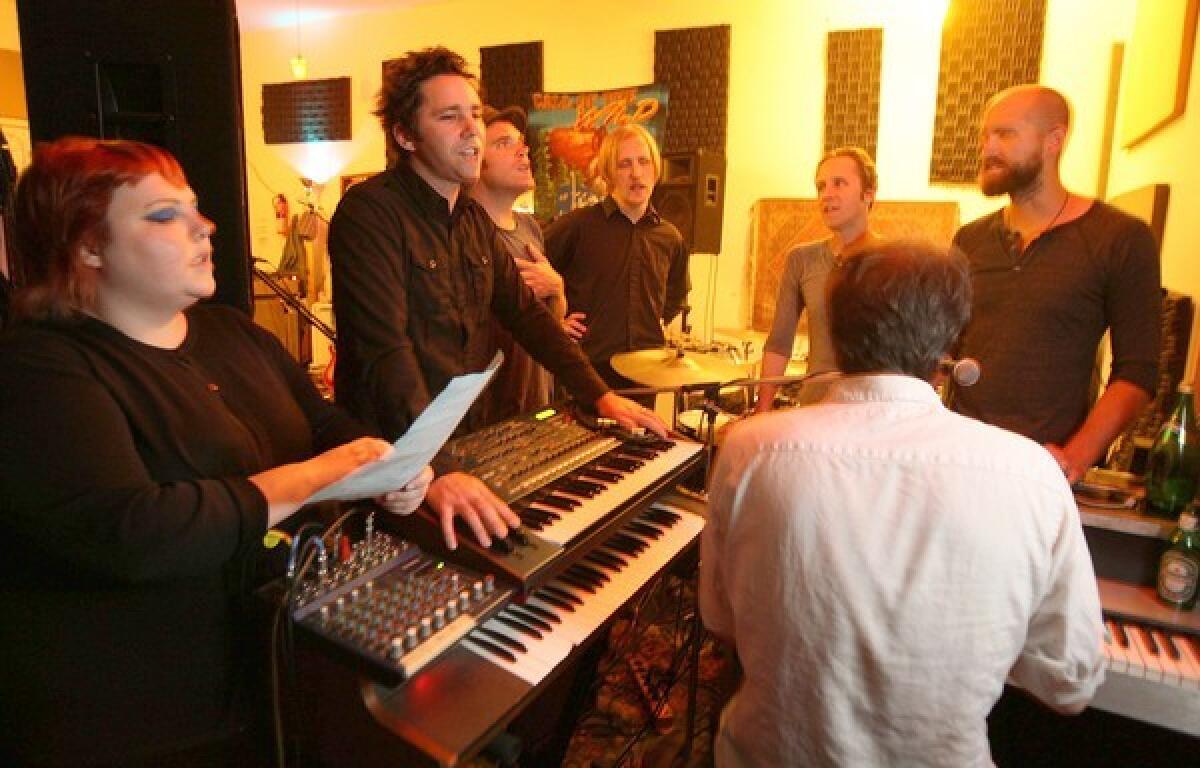 Members of the L.A. band the Afternoons -- from left, Claire McKeown, Steven Scott, Brian Canning, Tom Biller, Brent Turner, Sam Johnson and Aaron Burrows at the keyboards -- practice in the studio. They're changing the band's name to Shadow Shadow Shade to avoid being confused with other bands on Google searches.