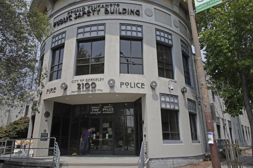 A worker makes repairs to the damaged Berkeley police headquarters on Wednesday, July 15, 2020, in Berkeley, Calif. 