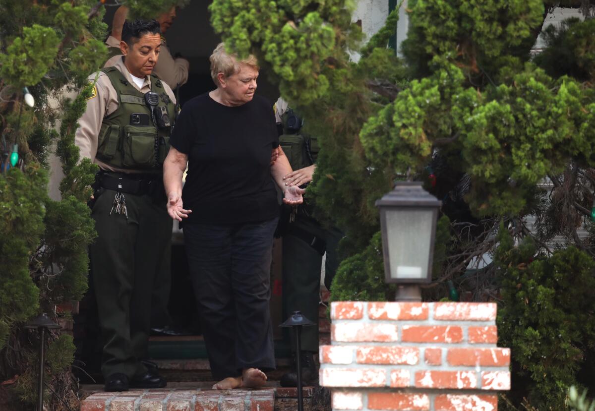 Supervisor Sheila Kuehl exits her house during a search by the L.A. County Sheriff's Department.