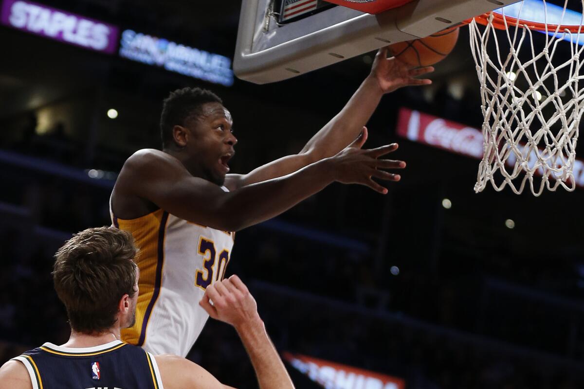 Lakers forward Julius Randle slips a reverse layup over Jazz forward Jeff Withey late in the fourth quarter.