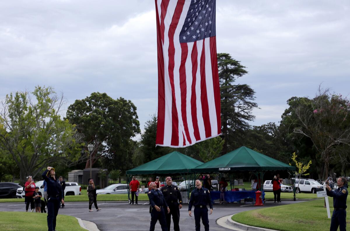 Orange County firefighters raise the U.S. flag at the Walk to Remember Memorial service. 